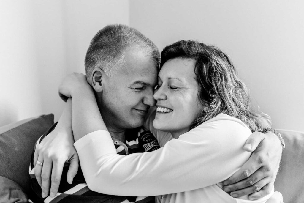 Happy couple embracing, representing improved health and well-being after addressing symptoms of hormone imbalance in men