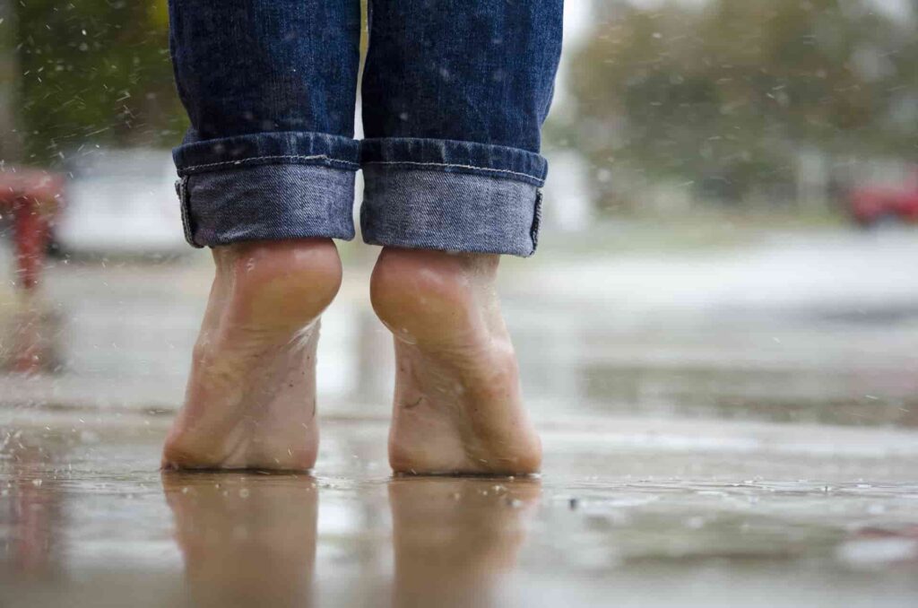 a person's feet in the rain