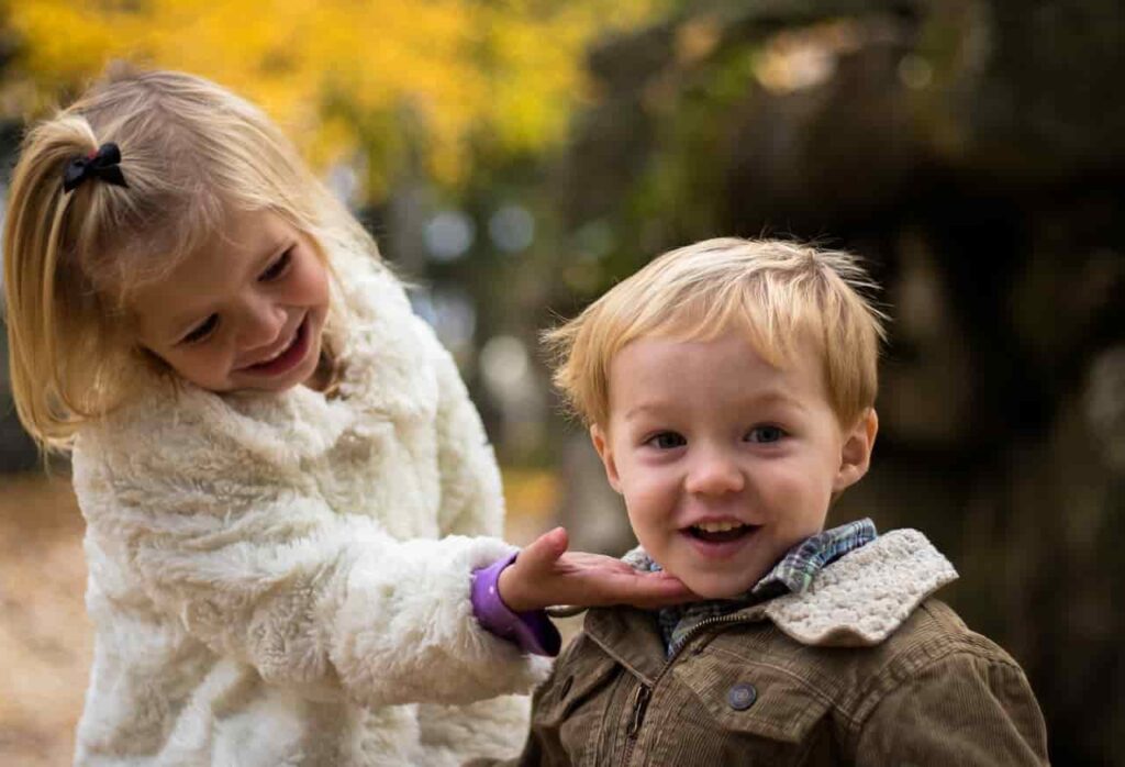 a girl touching a boy's neck