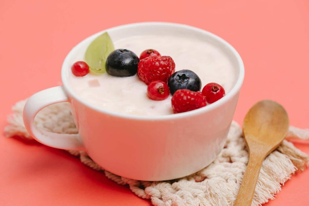 a cup of yogurt with berries on top