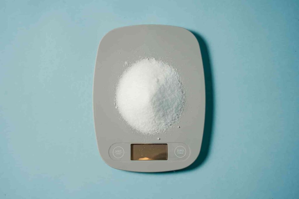 a scale with a pile of white powder on it