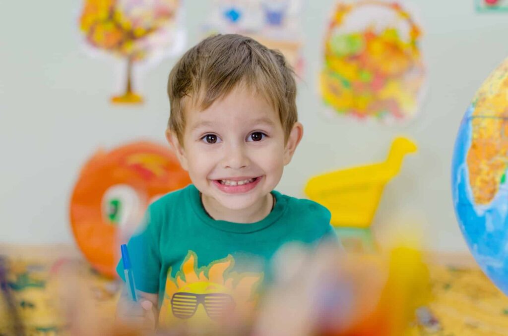 A fun kid waiting for his snacks at school