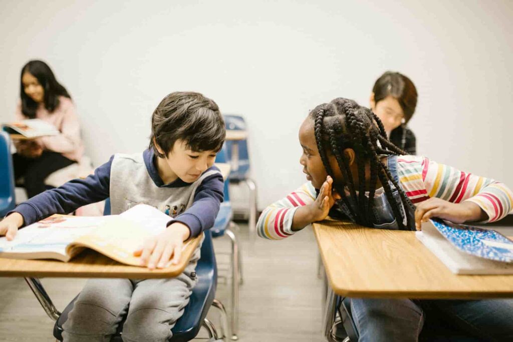 The children sit and talk about posture