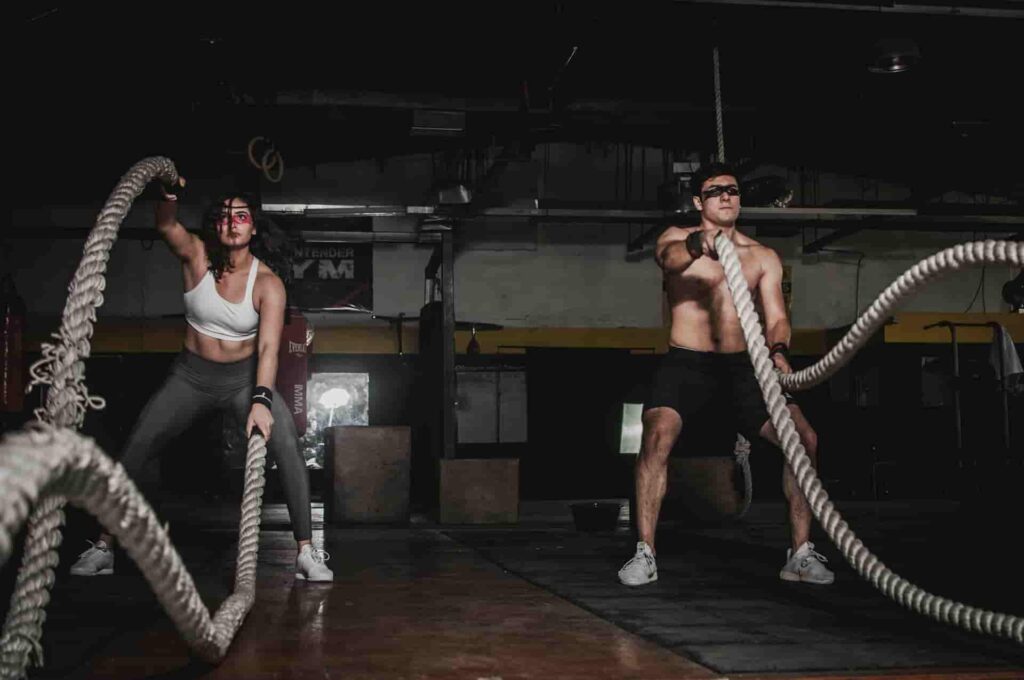 A man and a woman train for circuit training exercises